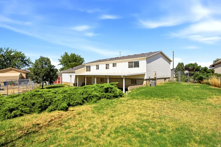 Two-story residence with white siding and a covered patio area