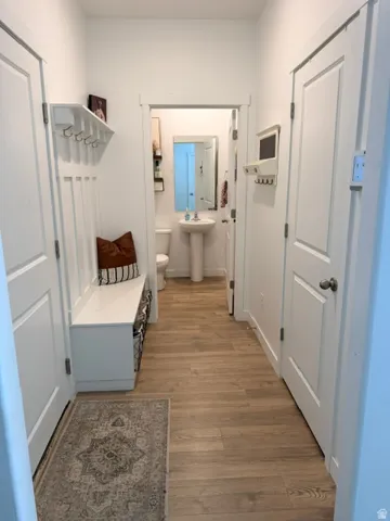 Entryway featuring wood-look flooring and white trim