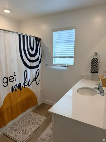 Bathroom with a single vanity, a recessed sink, and a chrome faucet