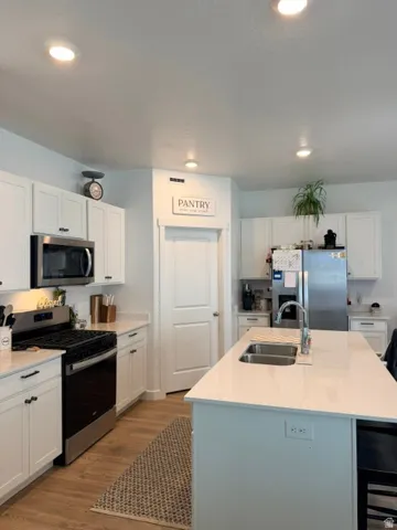 Modern kitchen featuring white cabinetry and stainless steel appliances