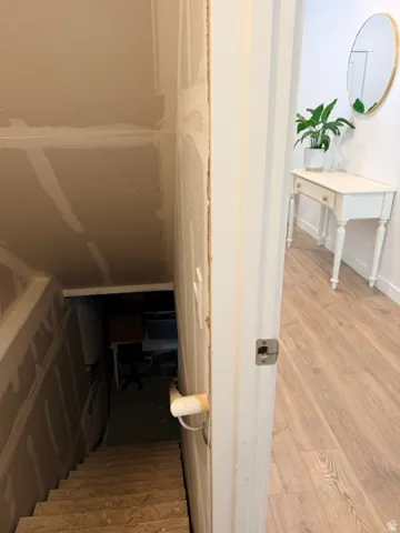 Wood-finish flooring extends throughout the hallway