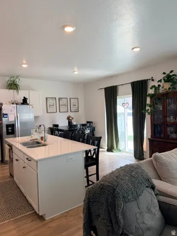 Kitchen island with a stainless steel sink and white countertop