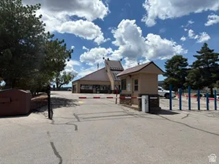 Gated entry with attendant booth featuring stone veneer detailing