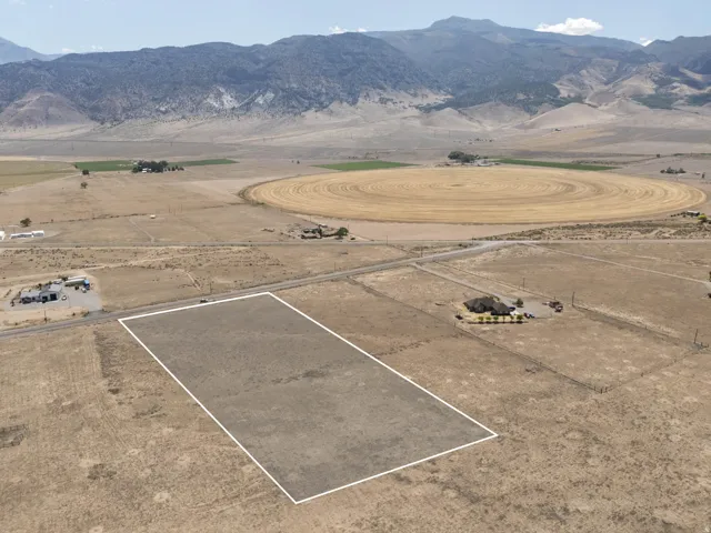 Expansive undeveloped land parcel with mountain backdrop