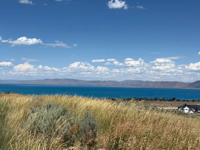 Expansive water body with distant mountain range under a clear sky