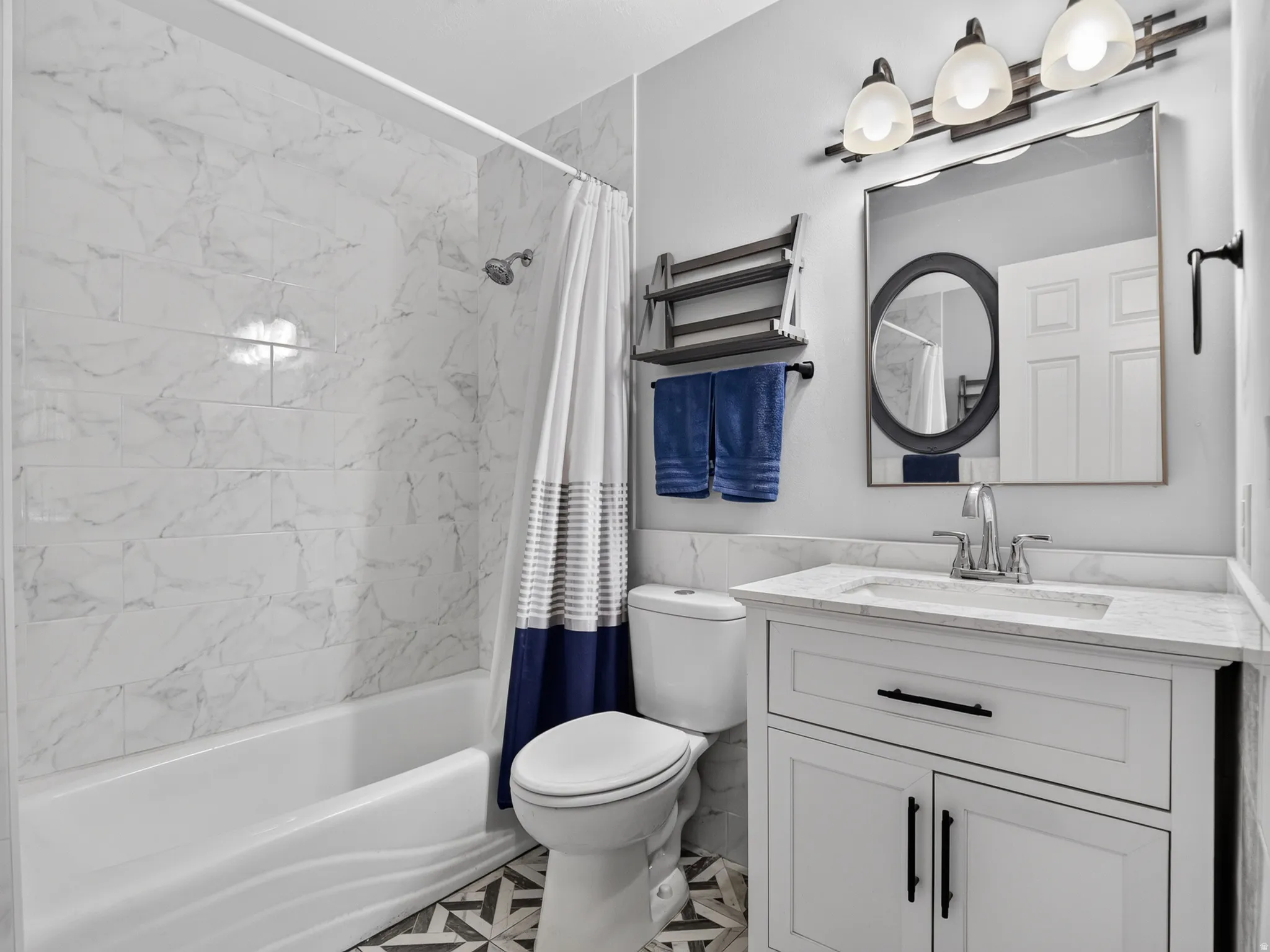 Master Bathroom featuring a white vanity with black hardware, an undermount sink, and a white marble-patterned countertop