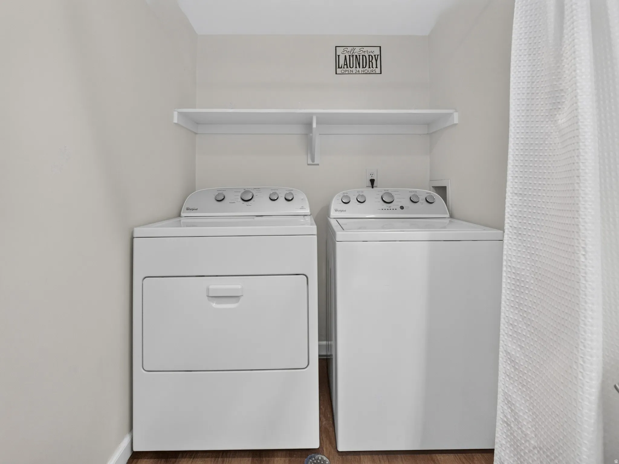 Dedicated laundry area featuring a white top-load washer and front-load dryer