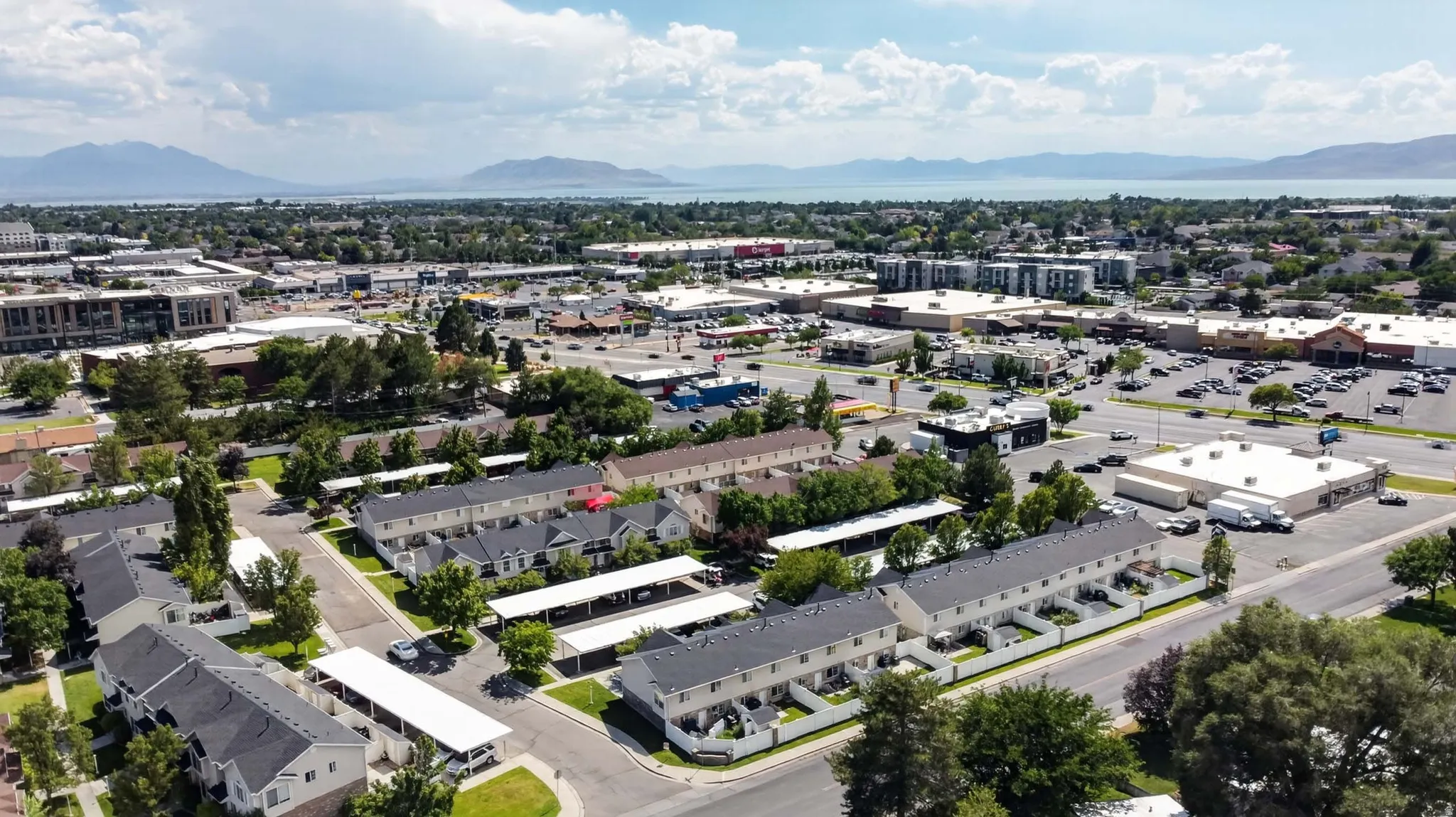 Aerial perspective showcasing multi-unit residential properties and surrounding commercial establishments