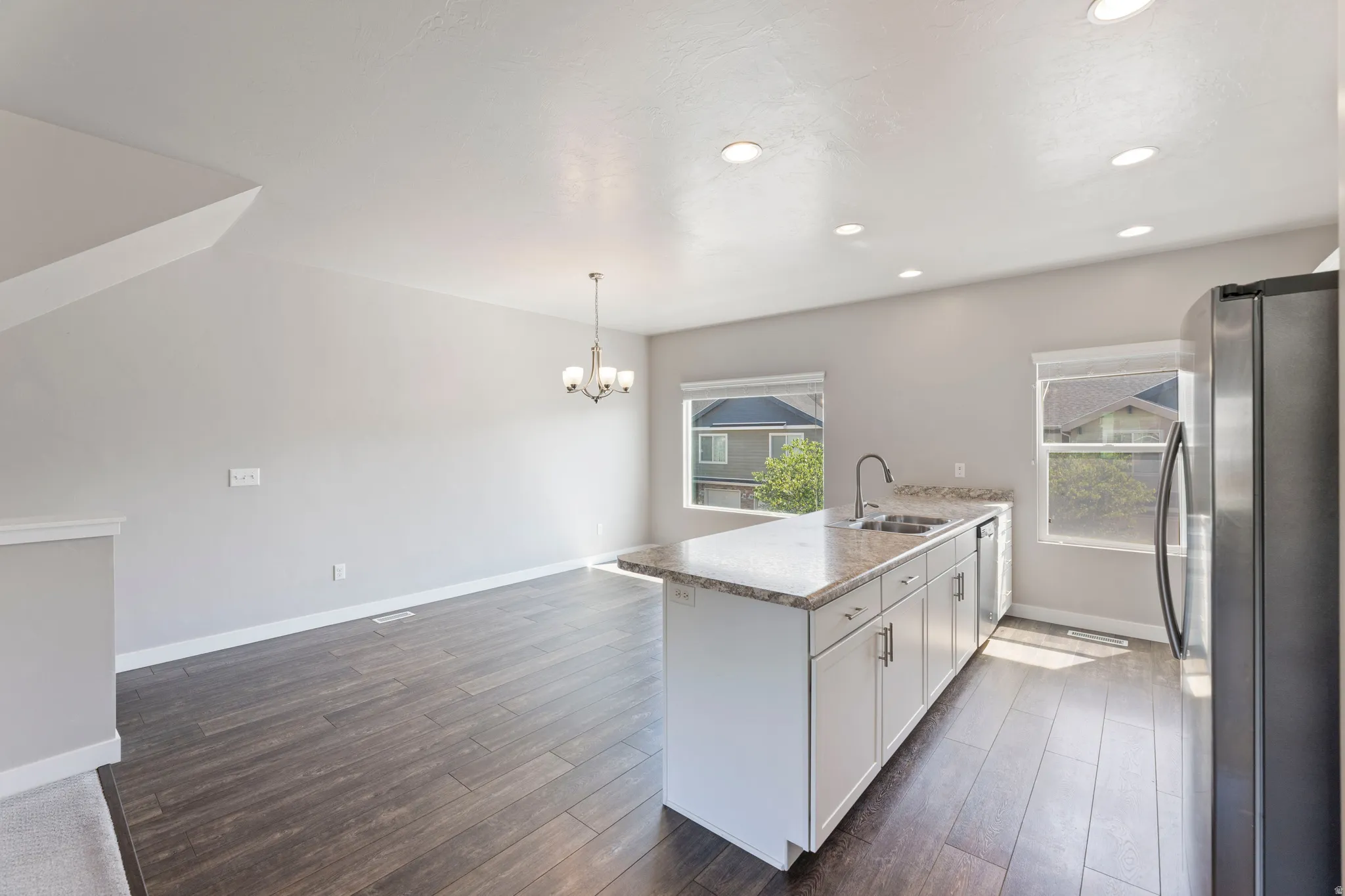 Open-concept kitchen and dining area featuring wood-finish flooring