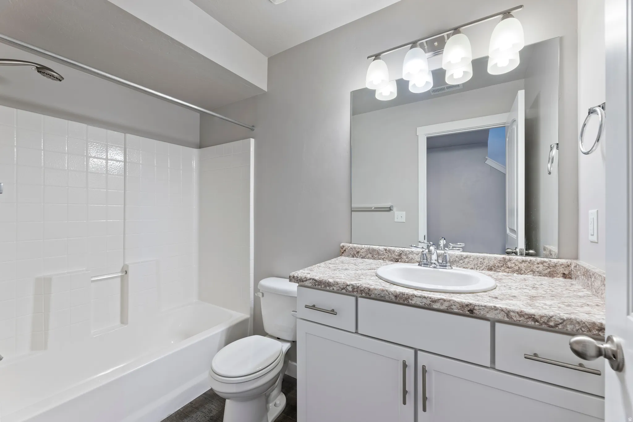1st floor Bathroom featuring a spacious vanity with an integrated sink, a large mirror, and a sleek light fixture