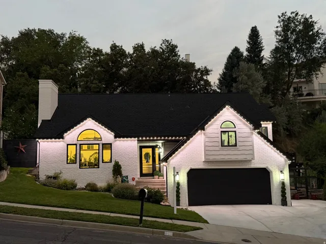 White brick and siding exterior with a black asphalt shingle roof