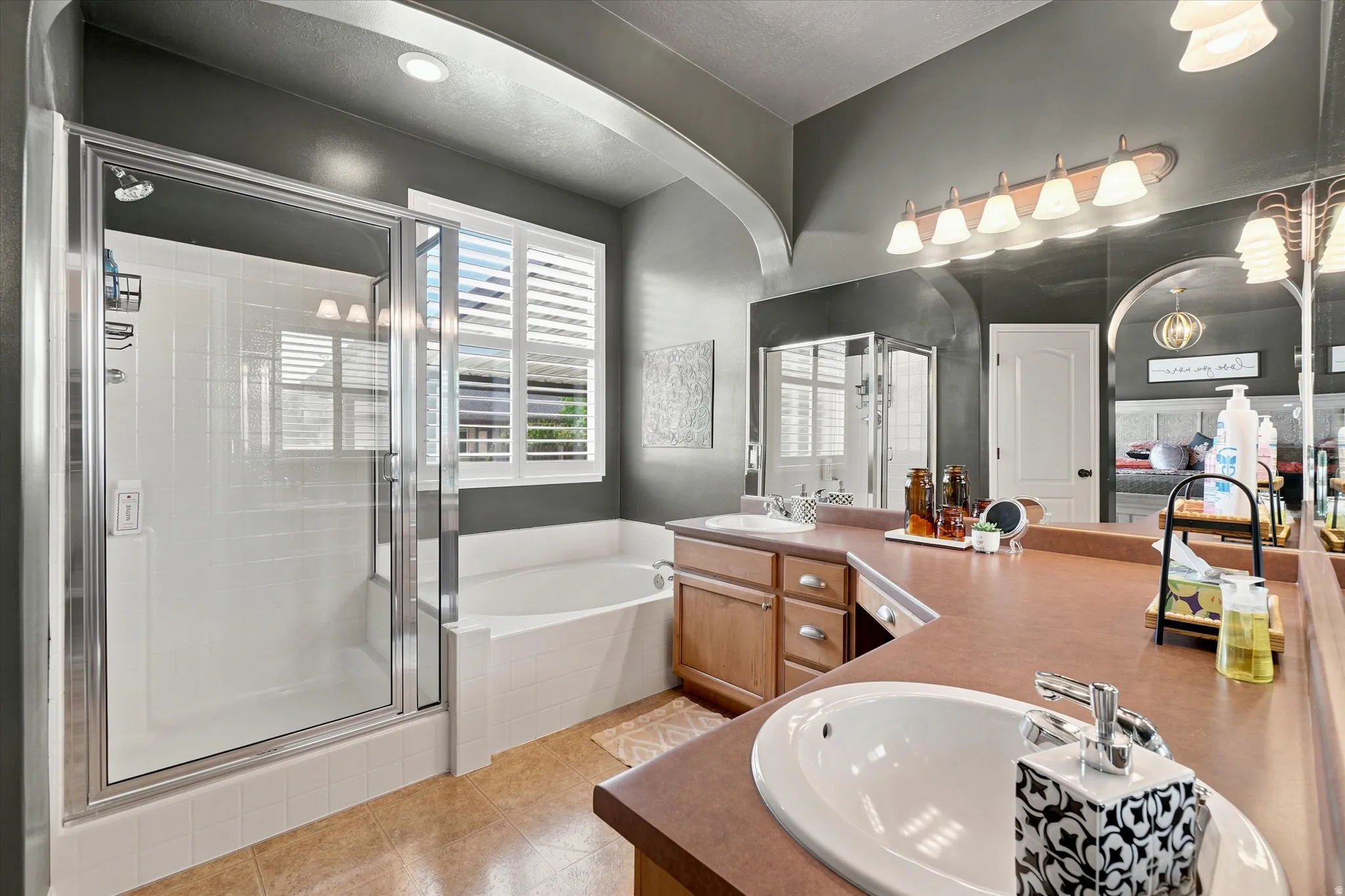 Double vanity with integrated sinks and wood-finish cabinetry, featuring an expansive countertop