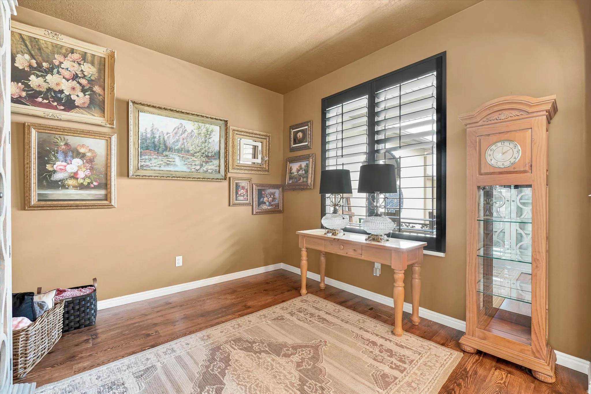 Rich wood-finish flooring complements the warm-toned walls