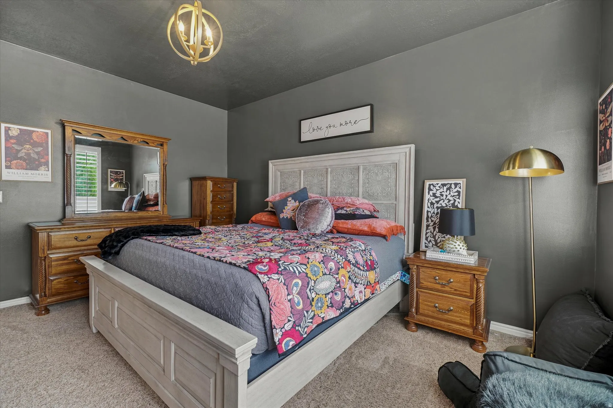 Bedroom featuring neutral-toned carpet flooring and a contemporary chandelier