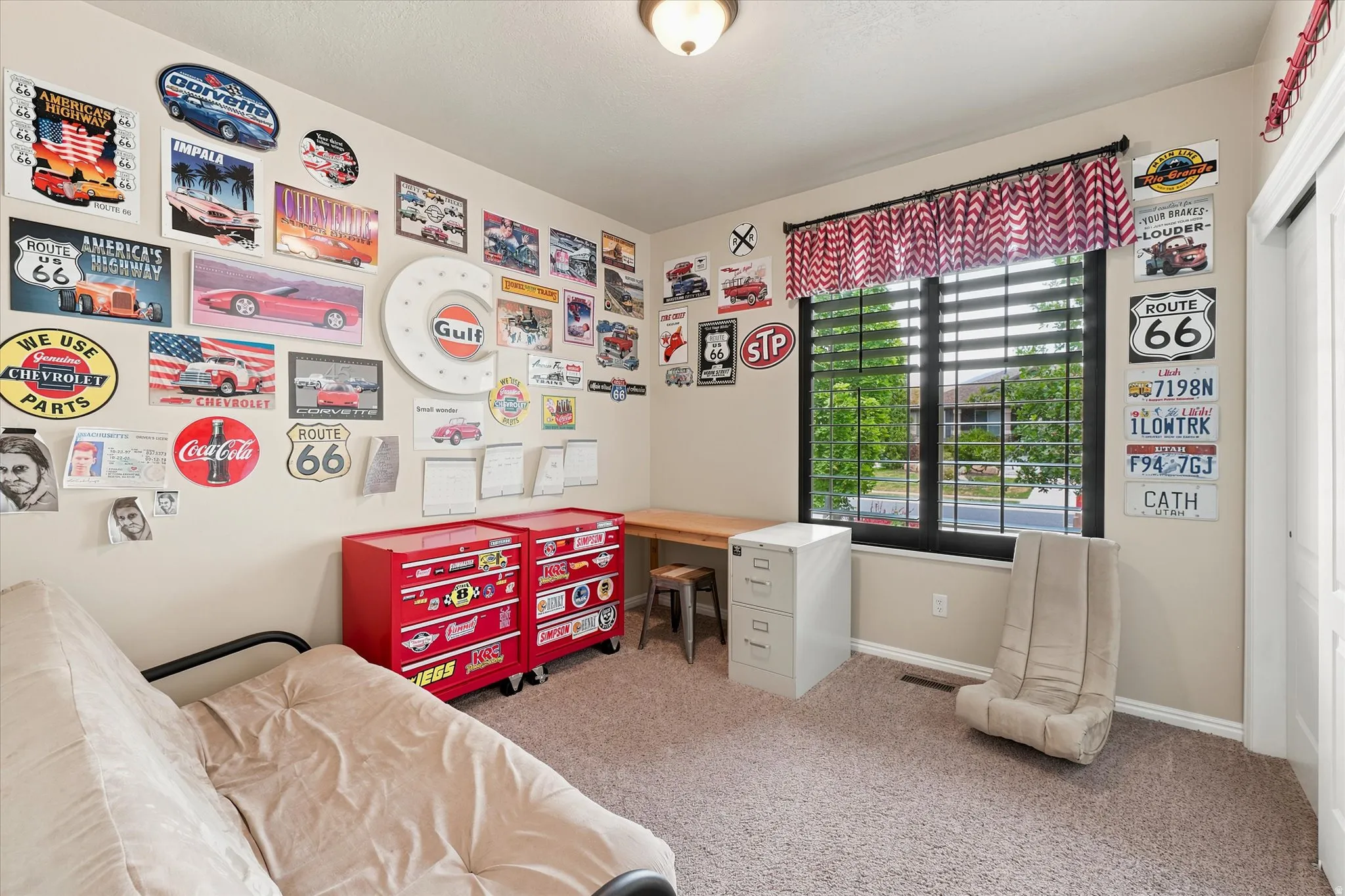 Carpeted room featuring a large window with horizontal blinds