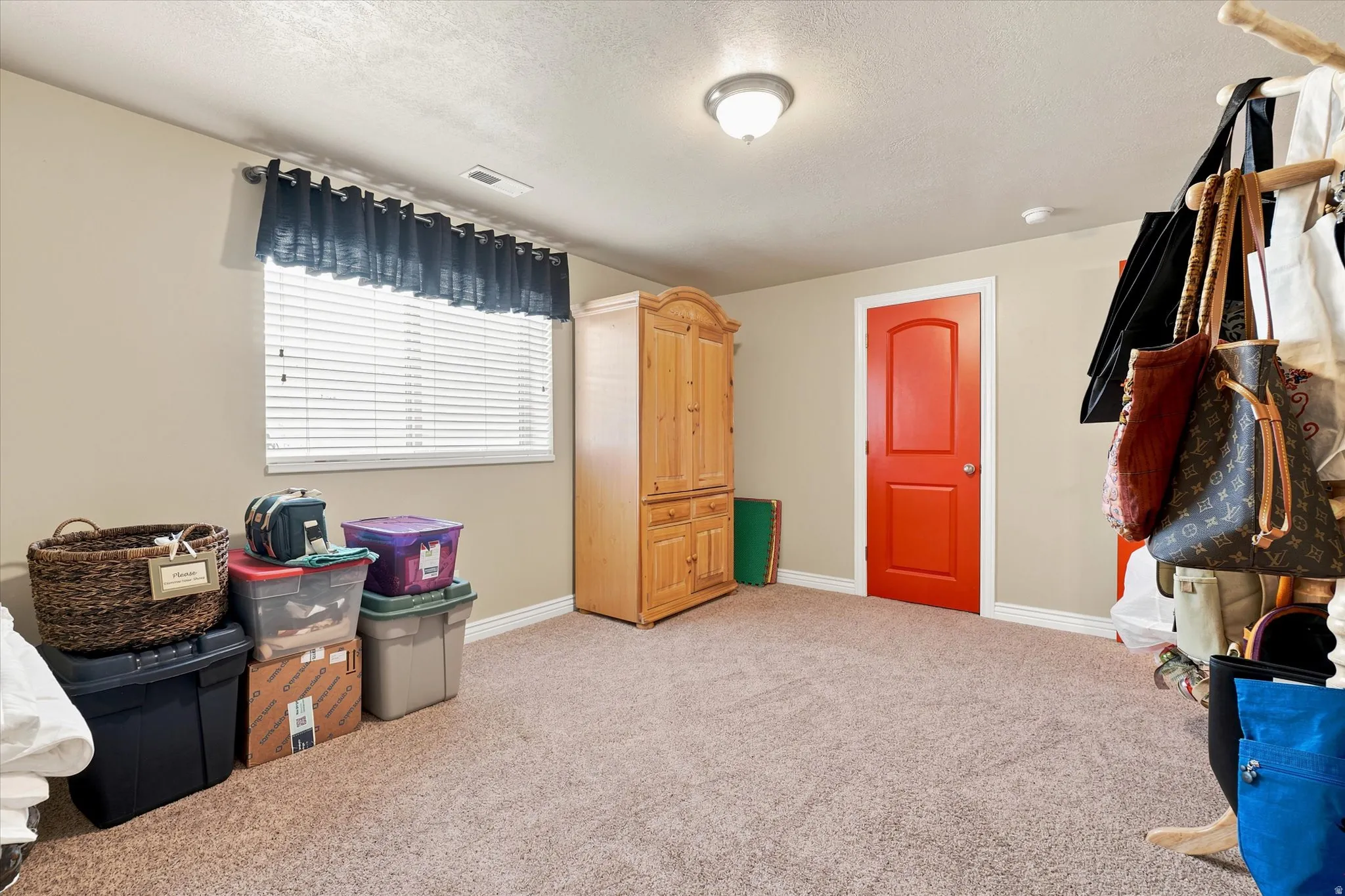 Room with neutral painted walls and a textured carpeted floor