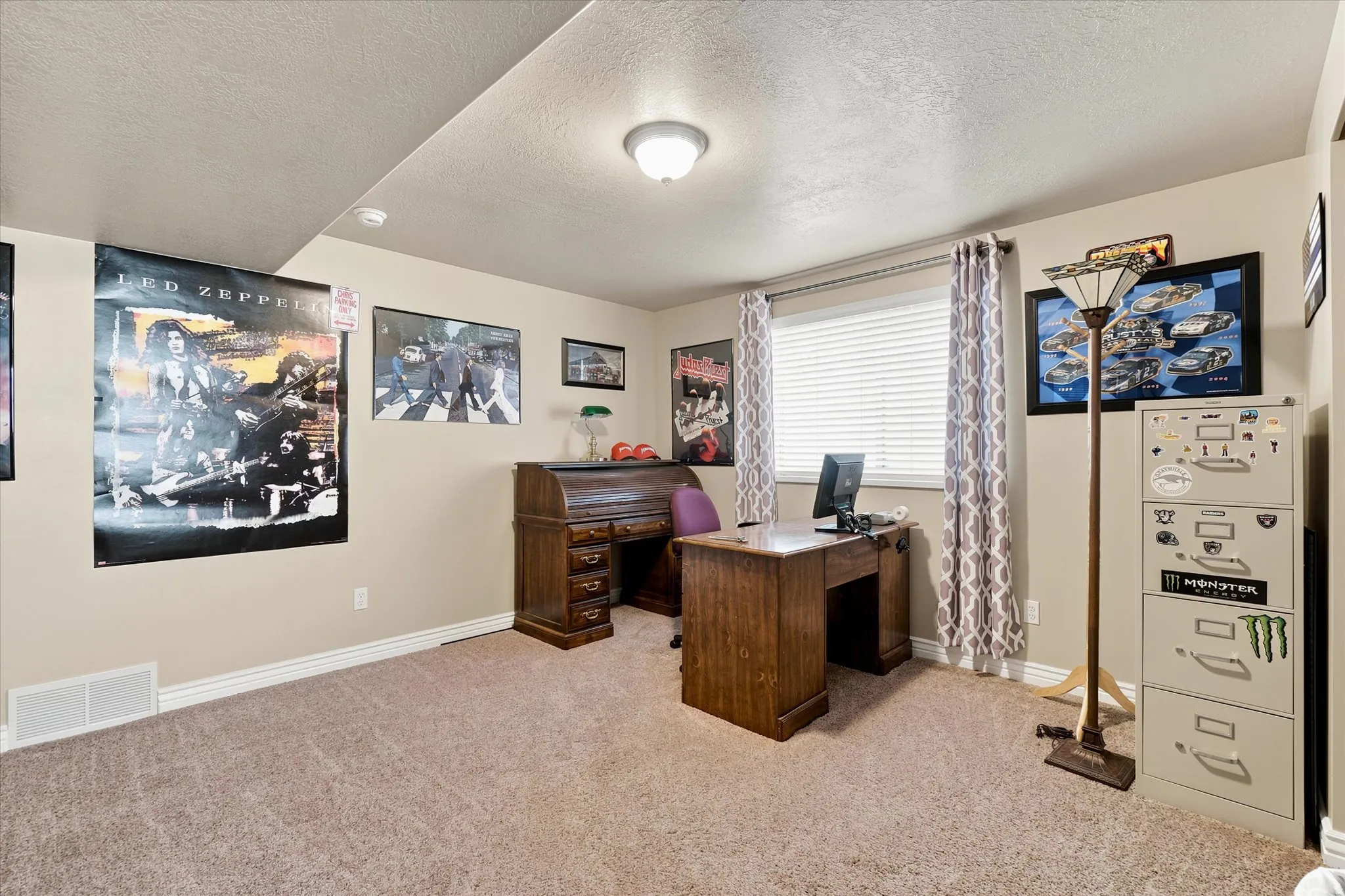Carpeted room with a window featuring horizontal blinds, recessed ceiling light, and light beige walls