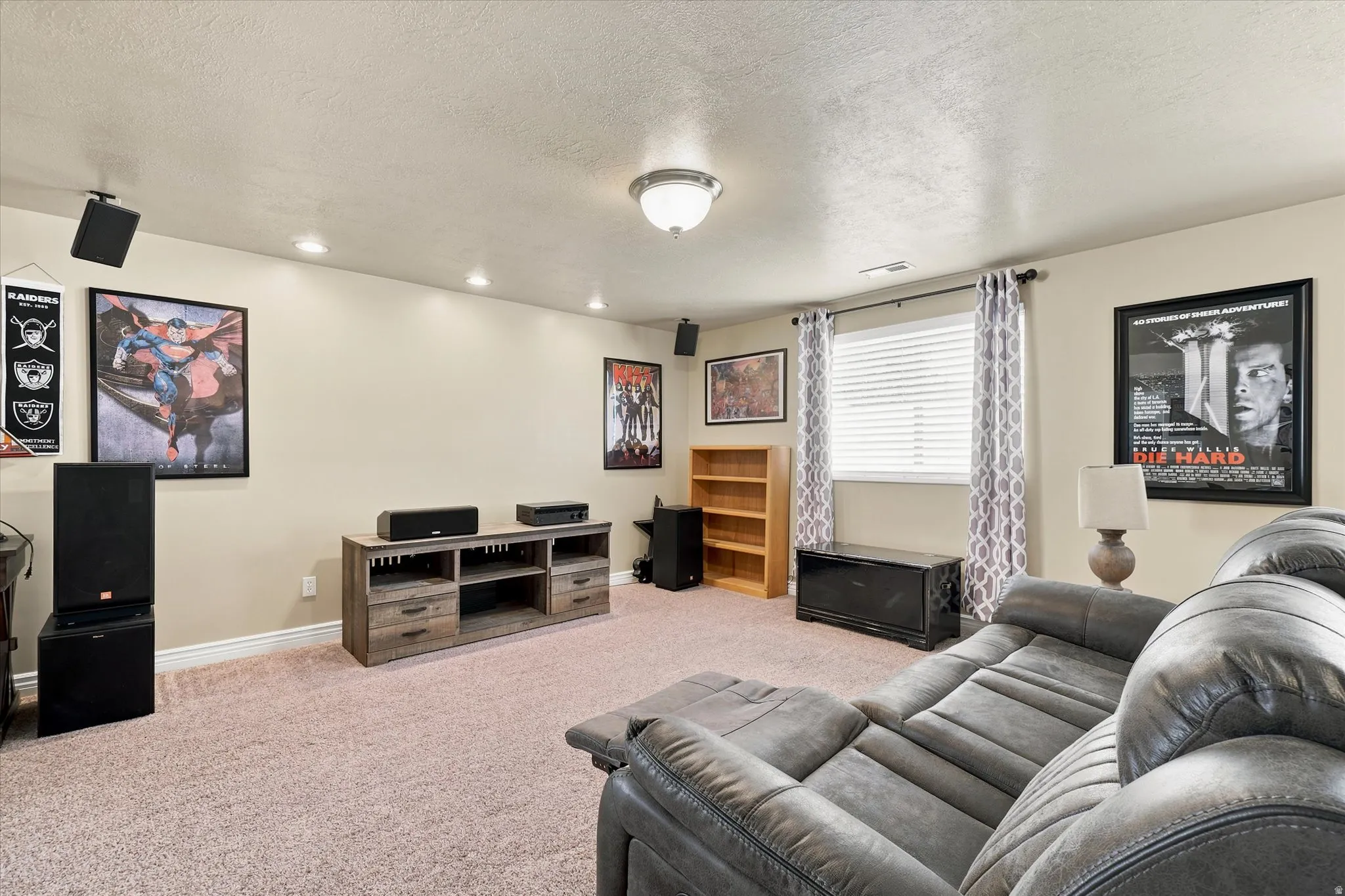 Carpeted room featuring recessed lighting and a window with blinds