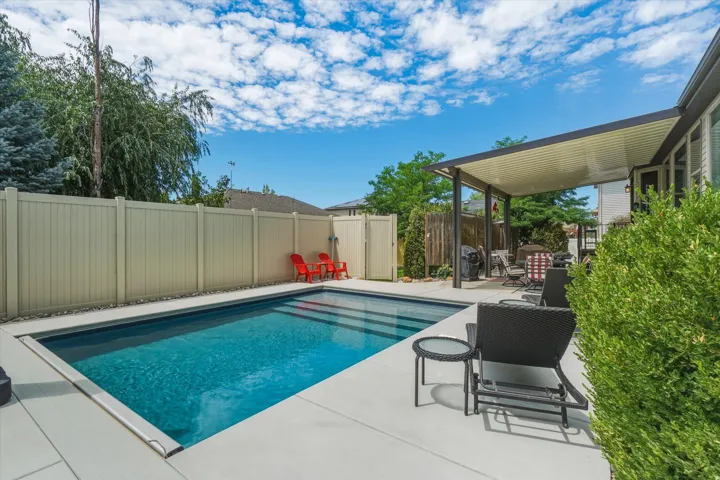 Outdoor swimming pool with integrated steps, surrounded by concrete decking