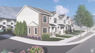 Corner unit townhome featuring a brick and siding exterior, landscaped entrance with mature shrubs, white trim windows, and a covered entryway