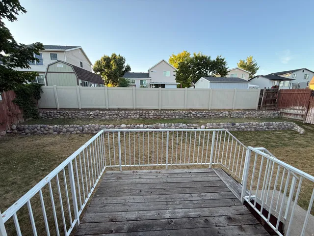 Rear wood-finish deck with white metal railings