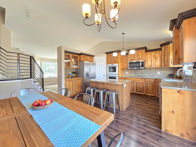 Open-concept kitchen and dining area featuring wood-finish flooring