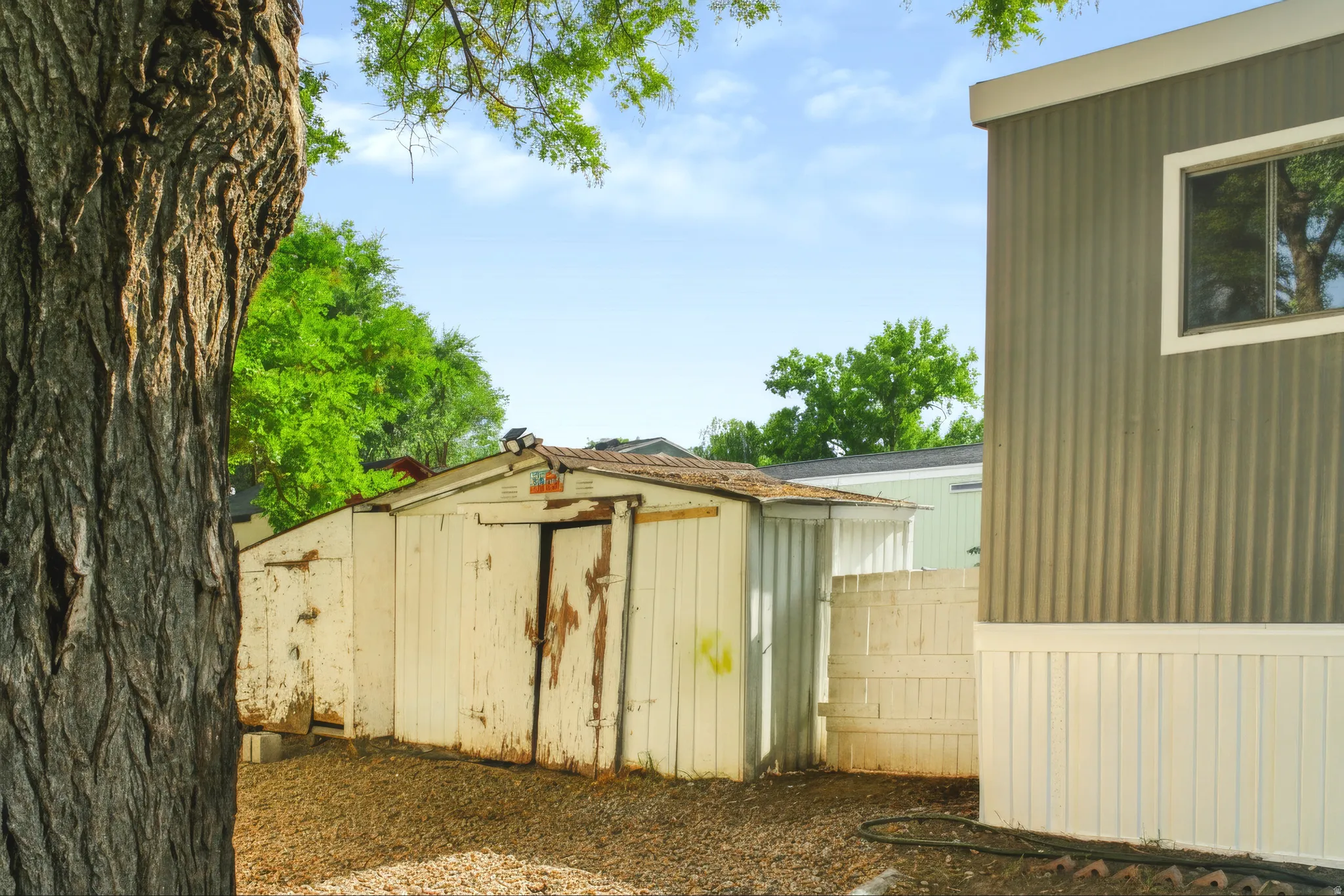 Detached storage shed with a panel siding exterior and a sloped roof