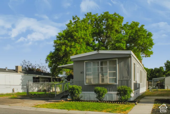 Gray-paneled exterior with white trim and a covered front entry