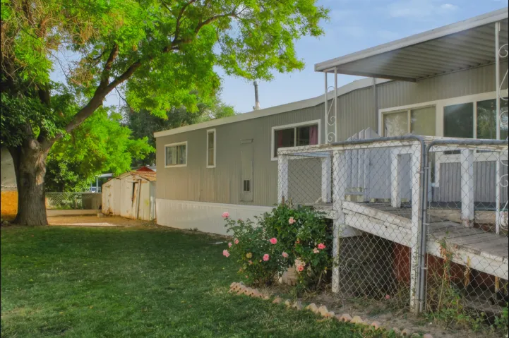Property exterior featuring a gray siding facade, white trim, and a covered porch
