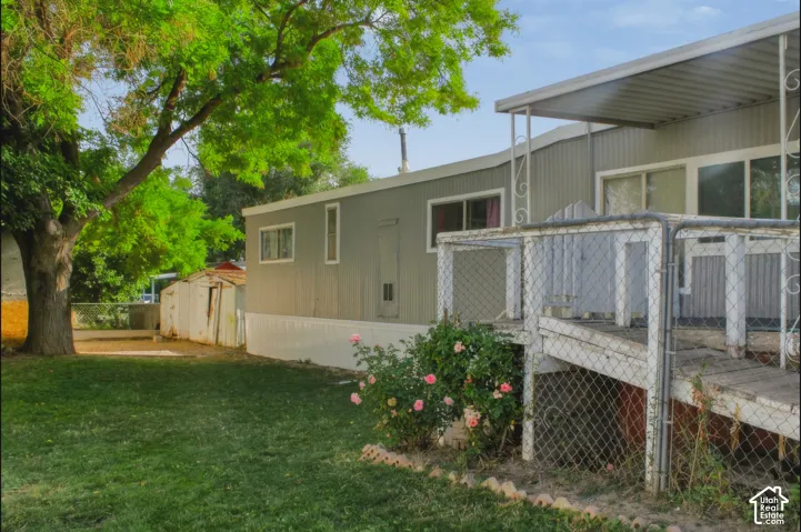 Property exterior featuring a gray siding facade, white trim, and a covered porch