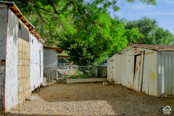 Gravel lot with 4 sheds 2 on each side.