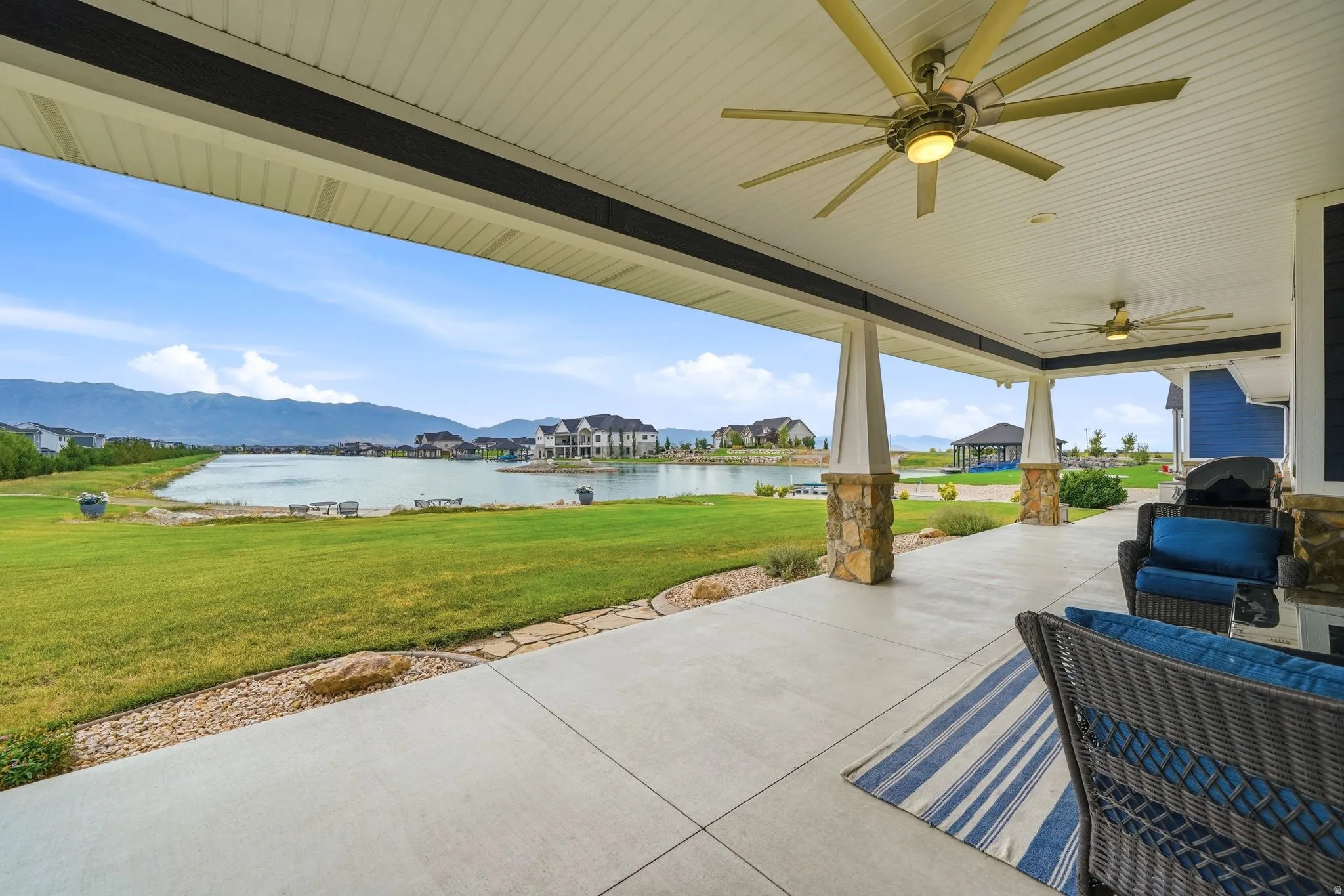 Covered patio with patio furniture, BBQ, two ceiling fans, and direct kitchen access