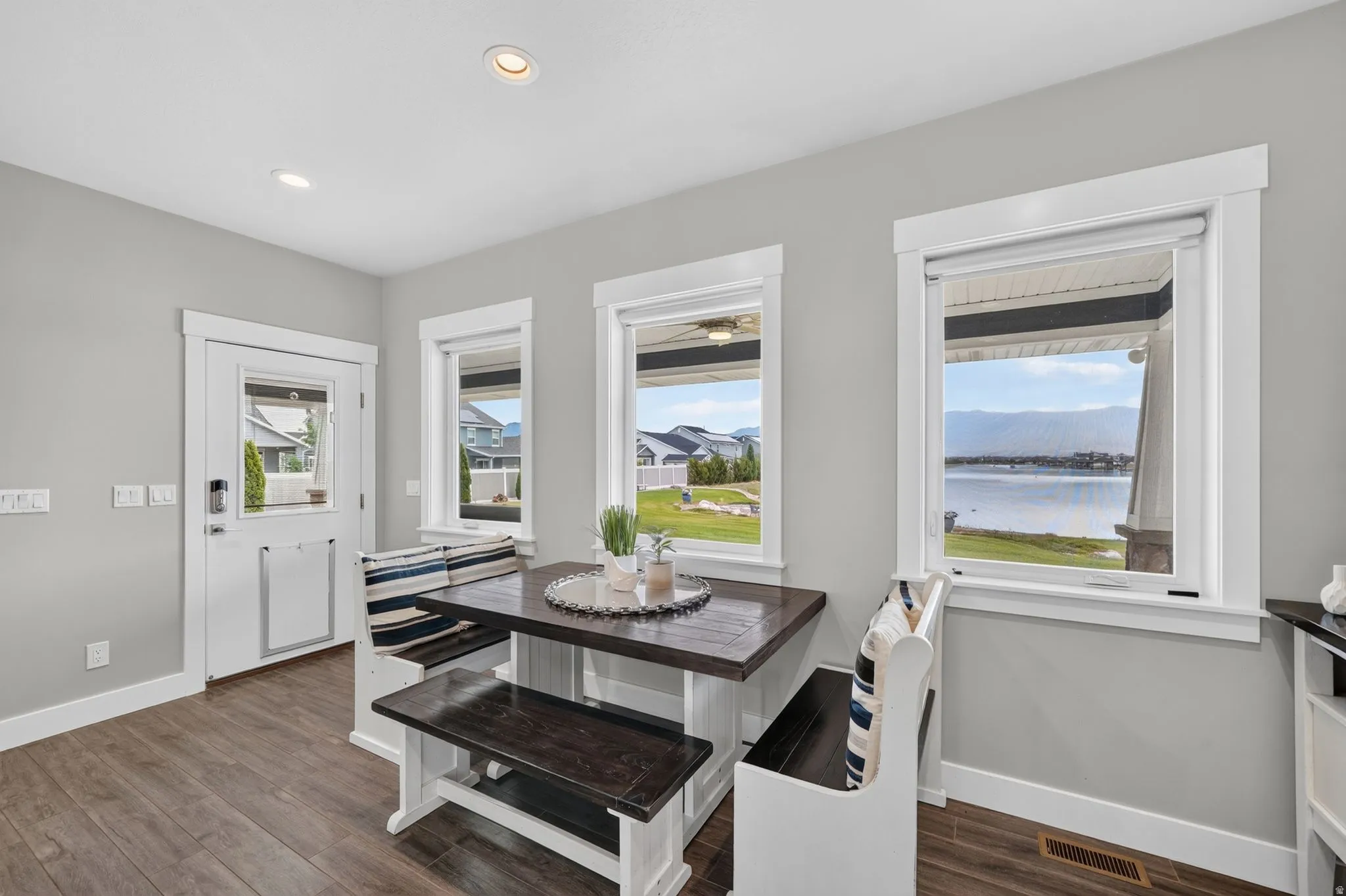 Dining area with rich wood-finish flooring and a built-in banquette
