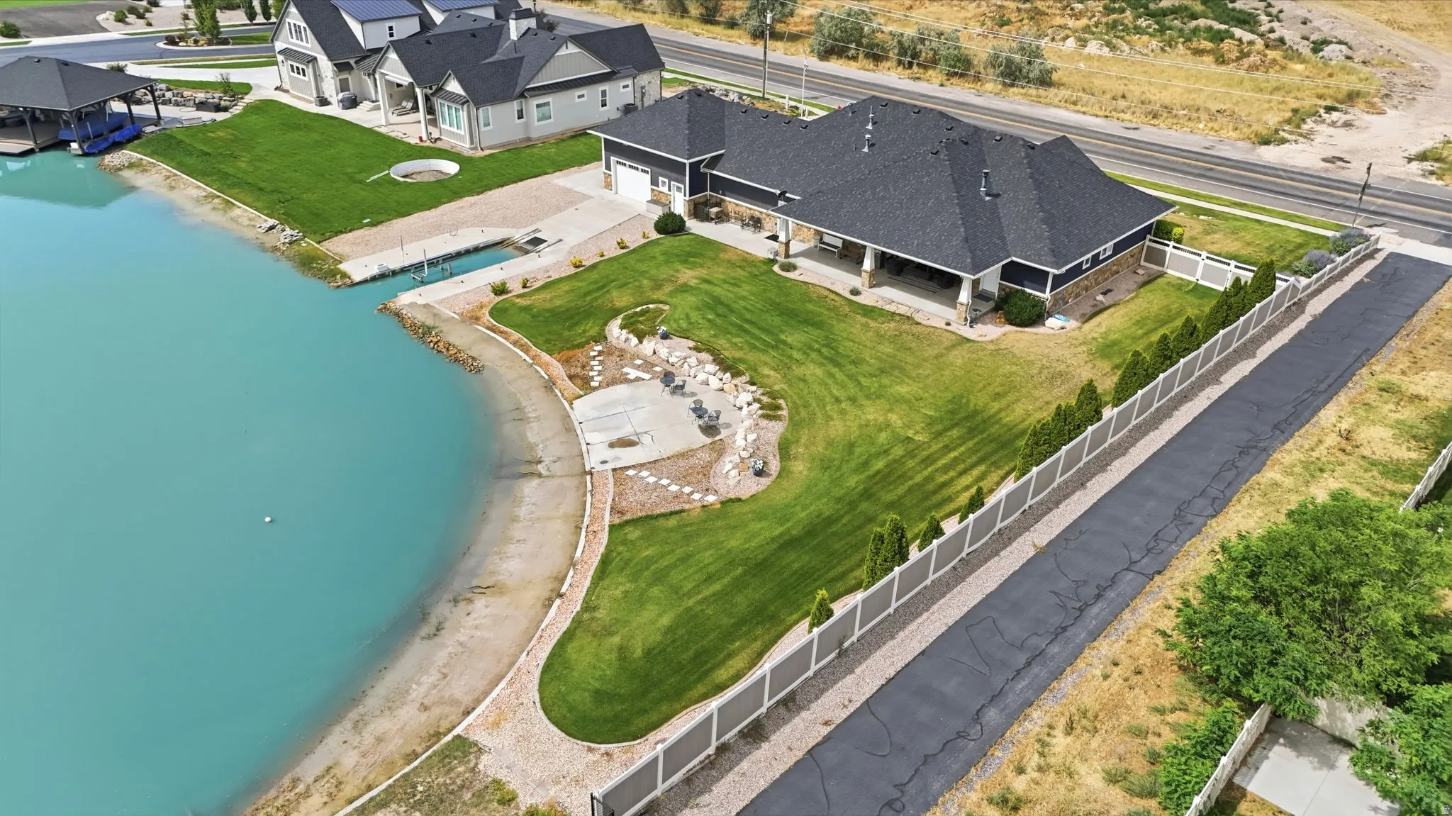Expansive waterfront property featuring a private dock, and covered patio