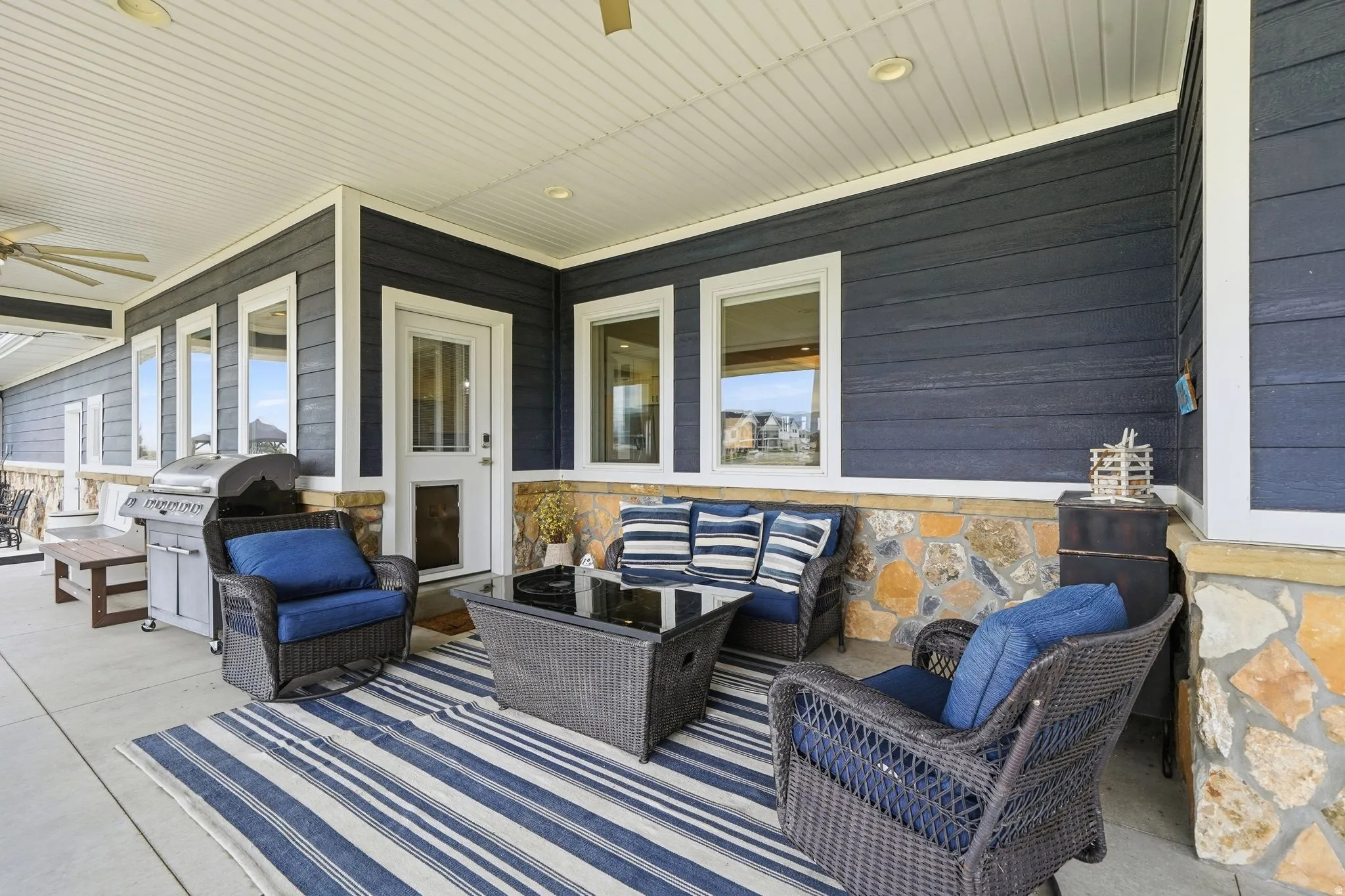 Covered concrete patio with direct kitchen and primary bedroom access