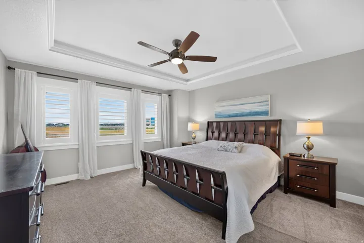 Primary bedroom with ceiling featuring a contemporary ceiling fan