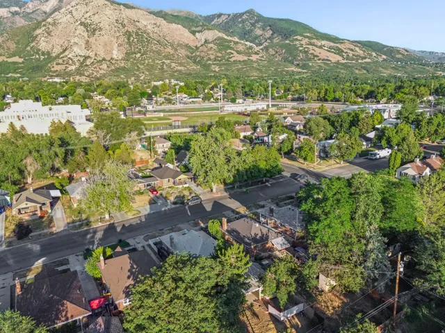 Residential neighborhood featuring mature trees and mountain scenery