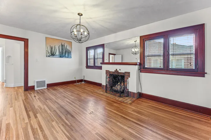 Hardwood flooring throughout the room, complemented by dark wood trim around windows and doorways
