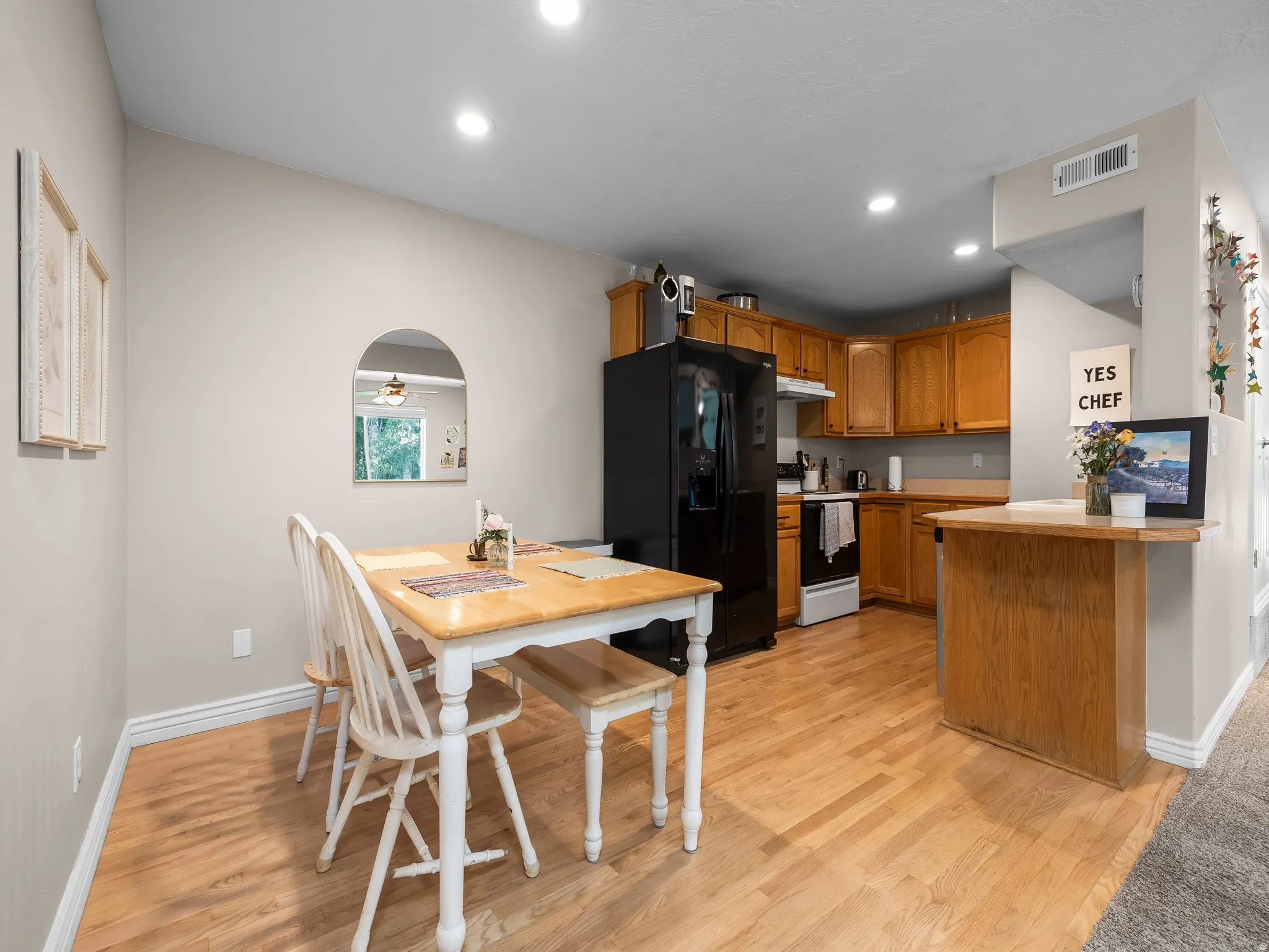 Open-concept kitchen and dining area with wood-finish flooring