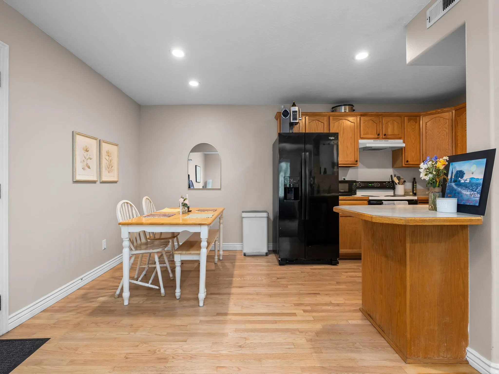 Open-concept kitchen and dining area featuring wood-finish flooring