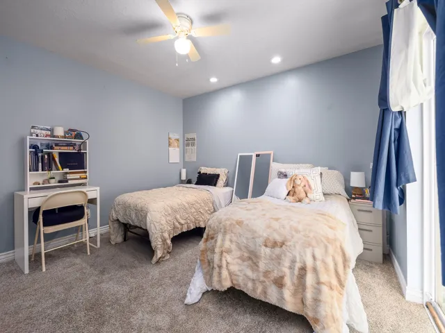 Bedroom featuring light blue walls and plush grey carpeting