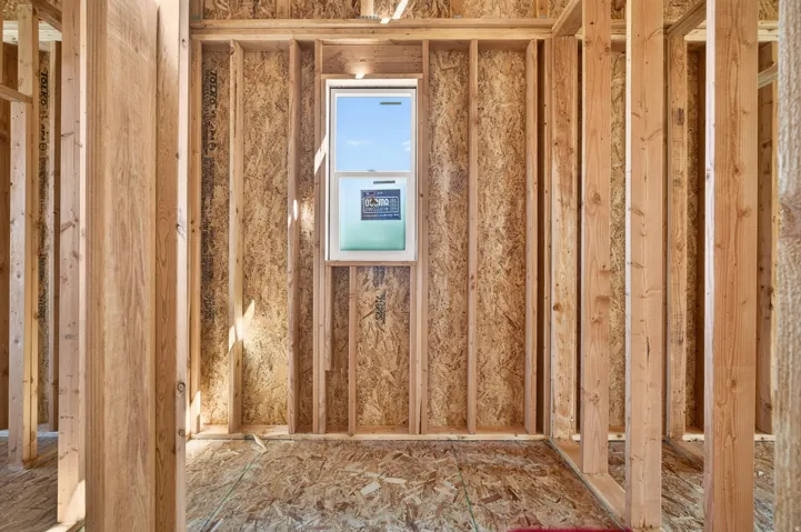 Interior framing featuring wood studs and oriented strand board sheathing