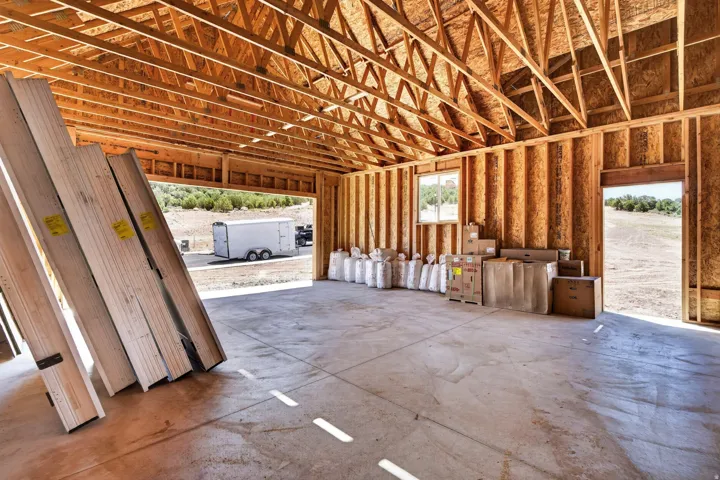 New construction framing showcasing a spacious interior with exposed wood beams