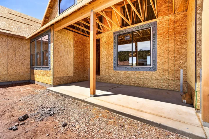 Covered concrete patio with exposed wood framing