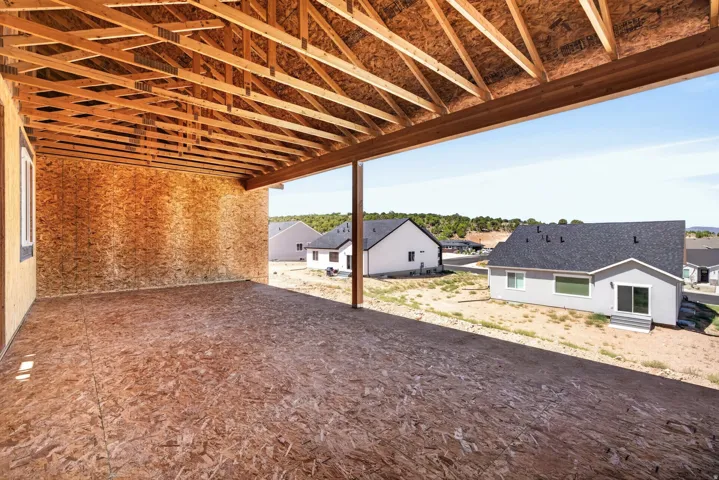 Expansive unfinished outdoor covered area with exposed ceiling joists