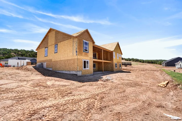 New construction home with a concrete foundation and two stories of wood sheathing