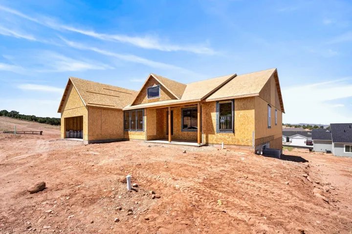 New construction opportunity featuring a multi-gable roofline, attached garage, and a covered entry porch