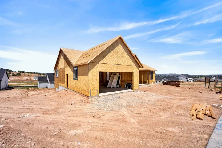 Single-story residence under construction featuring a gable roof design and an integrated two-car garage