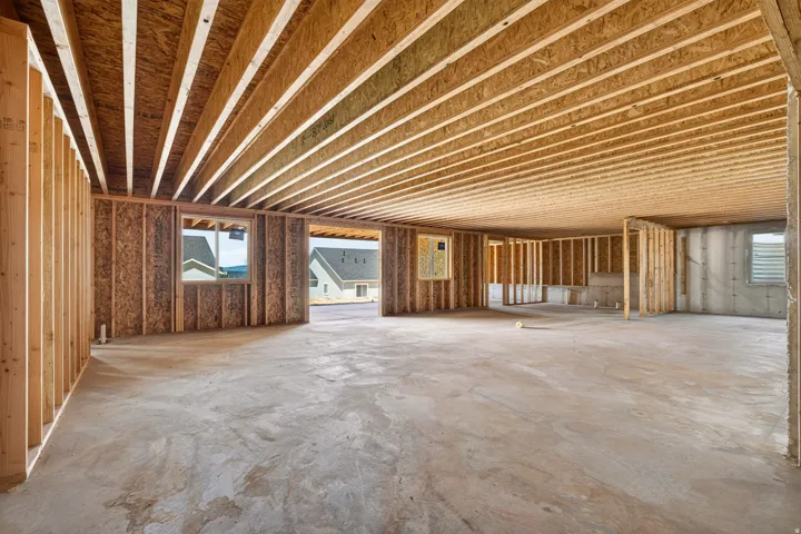 Expansive unfinished interior space featuring exposed wood joists and subflooring