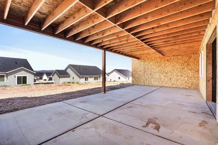 Covered concrete patio with an exposed wood joist ceiling